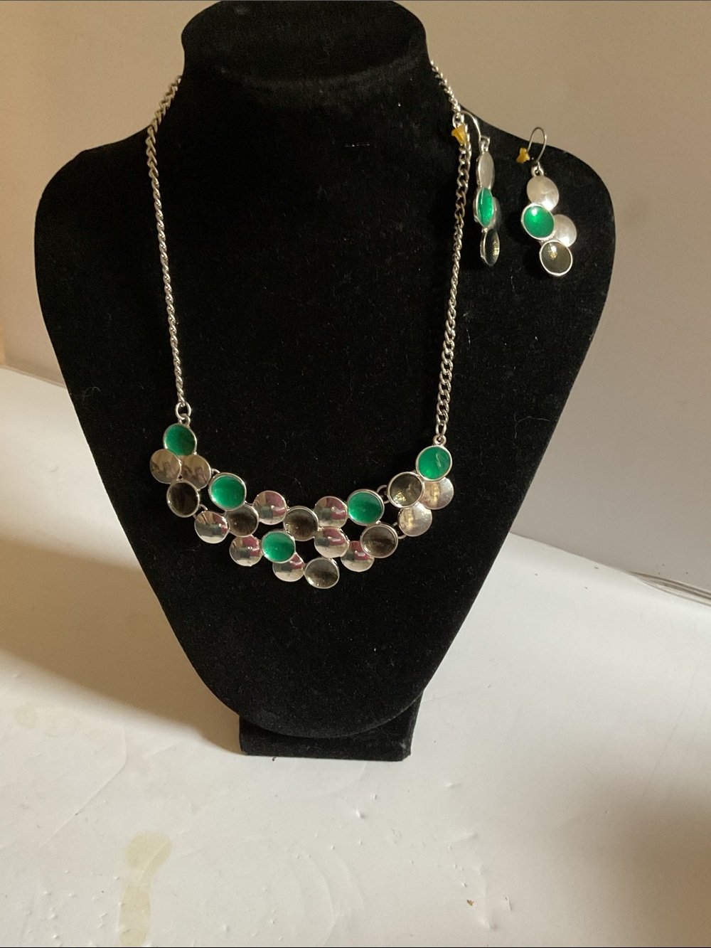 Silver tone and green necklace and matching earrings.
